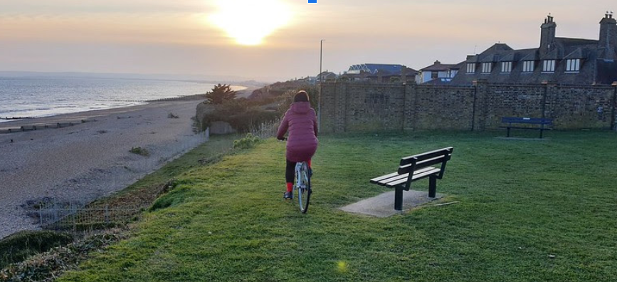 Photo of a woman cycling in the countryside