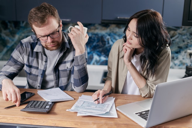 Couple discussing their bills at a table