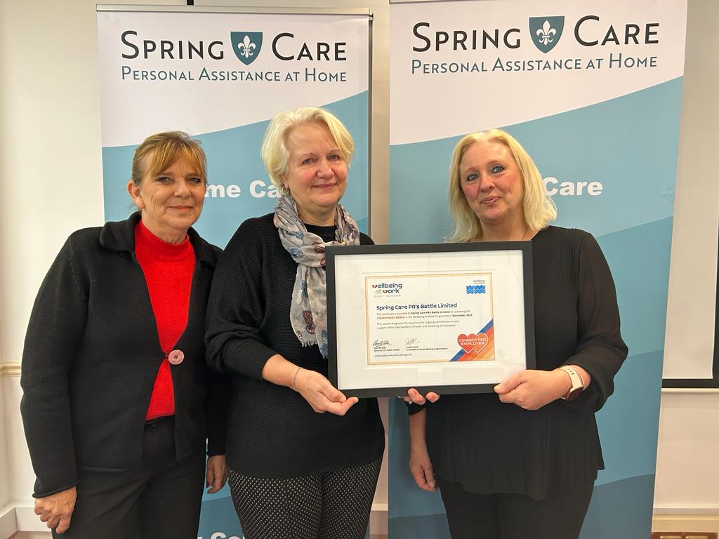 Spring Care colleagues with Commitment award certificate