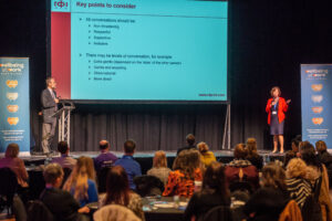 People presenting on stage