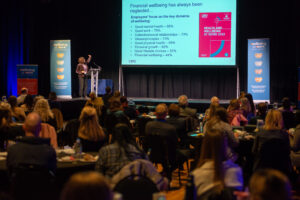 A woman presenting on stage