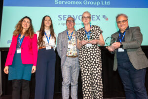 Two employees receiving an award on stage