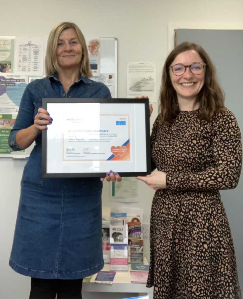 ESCC staff and Integrated Family Healthcare wellbeing lead employee awarded with framed certificate of Commitment Award Wellbeing at Work accreditation