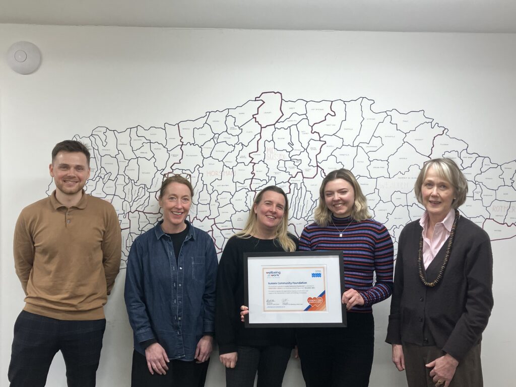 Staff and Wellbeing at Work team with the framed certificate
