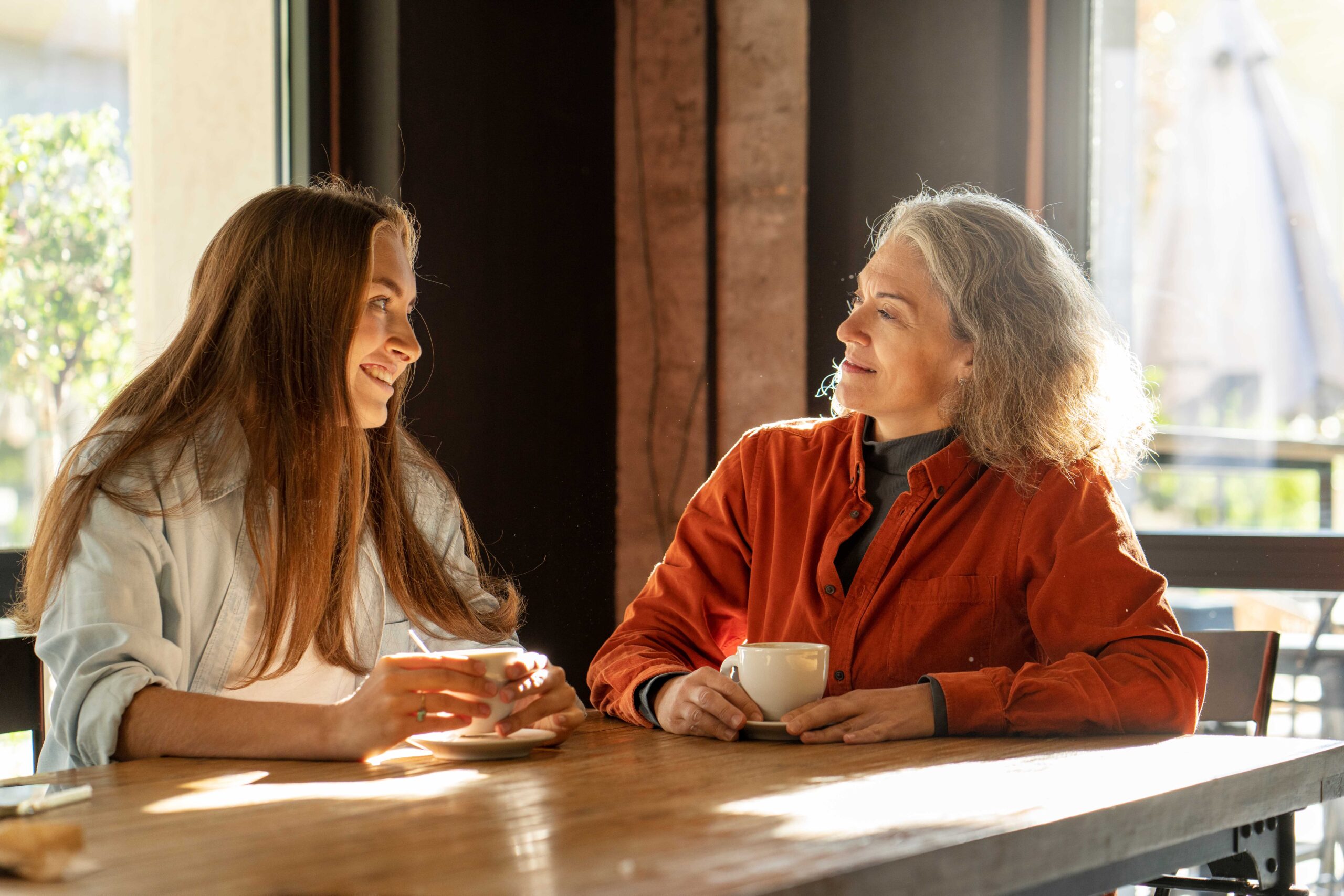 two women sitting in a cafe' drinking tea